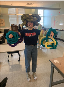 Photo of student holding mobiles strip